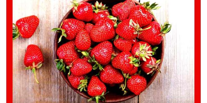 Fresh strawberry in a clay plate  on wooden table , top view